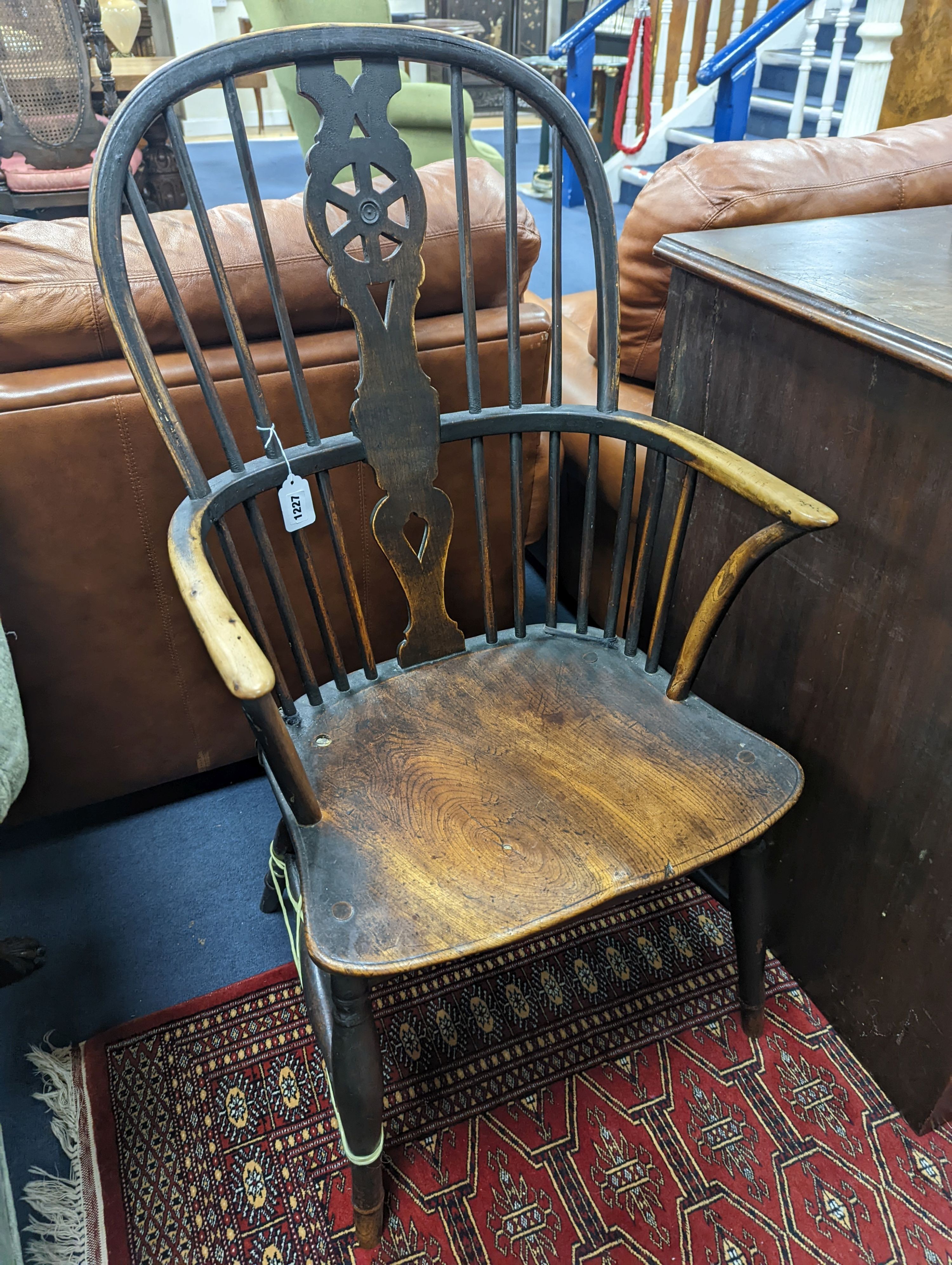 A 19th century elm and beech Windsor wheelback armchair, one leg a replacement, width 51cm, depth 41cm, height 101cm